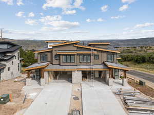 Contemporary house with a mountain view and stone siding