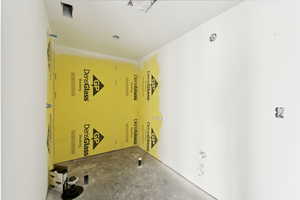 Empty room featuring unfinished concrete flooring