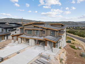 View of front of house featuring stone siding and a mountain view