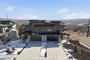 Contemporary home featuring a mountain view, a garage, and concrete driveway