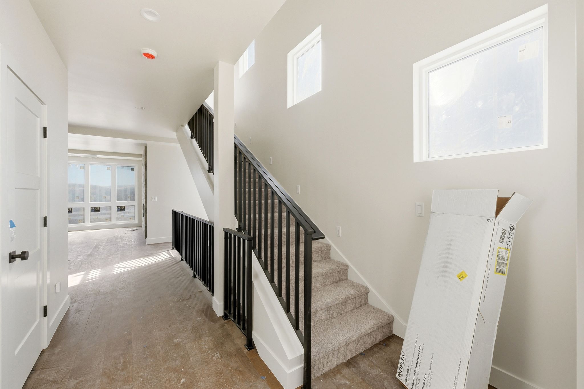 Stairs featuring wood finished floors and baseboards