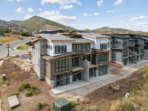 Rear view of property with a mountain view and a patio area