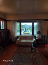 Living room featuring radiator and wood finished floors