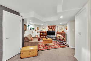 Living area with baseboards, carpet floors, and recessed lighting
