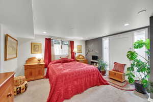 Bedroom with light carpet and recessed lighting