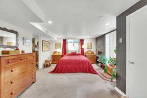 Bedroom with baseboards, visible vents, recessed lighting,and light carpet
