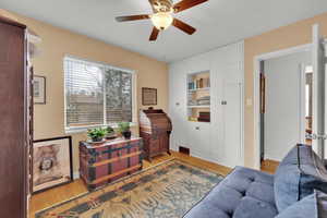 Sitting room featuring baseboards, ceiling fan, and light woodstyle flooring