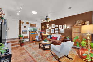 Living area featuring a ceiling fan