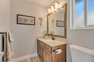 Half bath featuring toilet, vanity