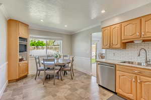 Kitchen featuring dishwasher, a wealth of natural light, tasteful backsplash