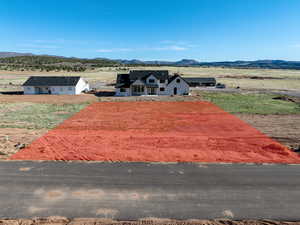 View of storm shelter with a rural view and a mountain view