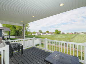 Wooden terrace with a lawn and fence