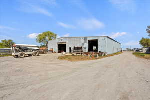 View of pole building featuring driveway