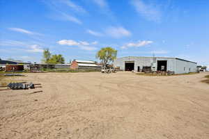 View of yard featuring an outbuilding, a pole building, and a garage