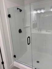 Full bath with a shower stall and a sink