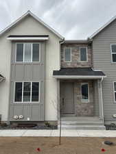 View of front of home with stone siding and stucco siding