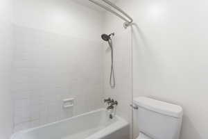 Full bathroom featuring shower / bathing tub combination and toilet