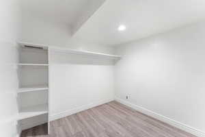 Spacious closet featuring wood finished floors