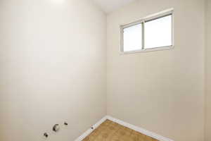 Empty room featuring light floors and baseboards