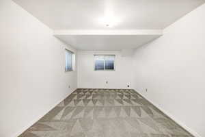 Spare room with carpet floors and baseboards