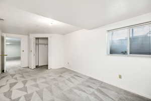 Unfurnished bedroom featuring a closet, visible vents, baseboards, and light carpet