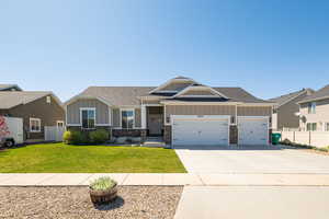 Craftsman-style house with board and batten siding, driveway, a garage, and fence