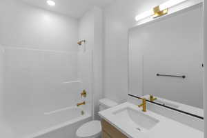 Full bath with shower / bath combination, vanity, and toilet
