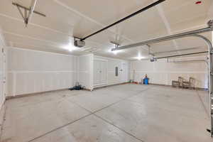 Giant 3-car garage with a man door and room for a shop or long vehicle parking.