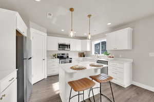 Kitchen featuring quartz countertops, stainless steel appliances, brass faucet and hardware, stainless steel sink, and recessed lighting