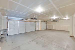 Giant 3-car garage with a man door and room for a shop or long vehicle parking.