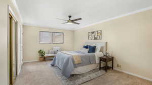 Bedroom featuring ceiling fan, carpet floors, baseboards, and ornamental molding