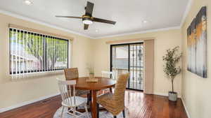 Dining area with plenty of natural light, visible vents, baseboards, and hardwood / wood-style flooring