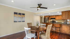 Dining room with dark wood-style floors, baseboards, recessed lighting, a ceiling fan, and ornamental molding