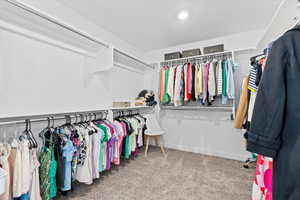 Oversized walk-in closet with access through the primary bathroom