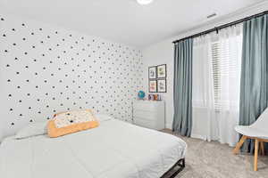 Spacious bedroom fitting a king bed, dresser and sitting area