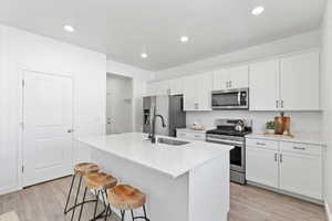 Kitchen featuring an over the range microwave with exhaust fan and access to the 3-car garage through the mudroom