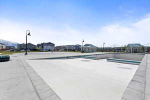 Community pool with splash pad and covered tables for picnic & barbecues