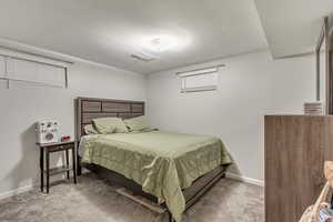 Carpeted bedroom featuring visible vents and baseboards