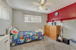 Bedroom with carpet floors and a ceiling fan