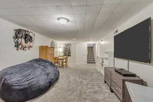 Interior space with visible vents, carpet flooring, and stairs