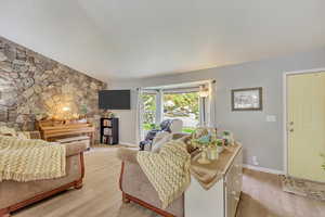 Living area with light wood finished floors and baseboards
