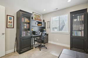 Office space with recessed lighting, visible vents, carpet floors, and baseboards