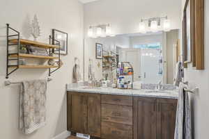 Full bath with double vanity, visible vents, and a sink