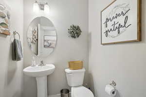 Bathroom with toilet and baseboards