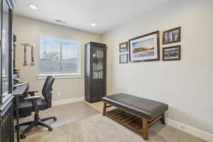 Home office featuring baseboards, visible vents, carpet floors, and recessed lighting