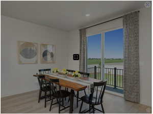 Dining area with a water view, baseboards, recessed lighting, and light wood finished floors