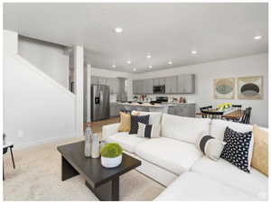 Living room with recessed lighting, stairs, and baseboards