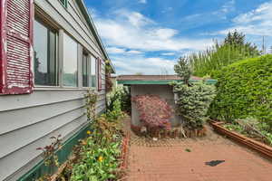 View of home's exterior featuring a patio area and an outdoor structure