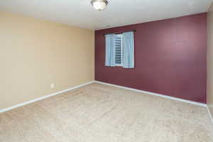 Spare room with carpet floors and baseboards