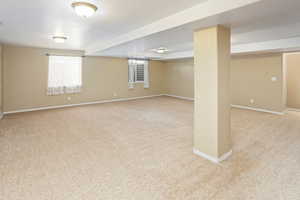 Basement with carpet floors and baseboards